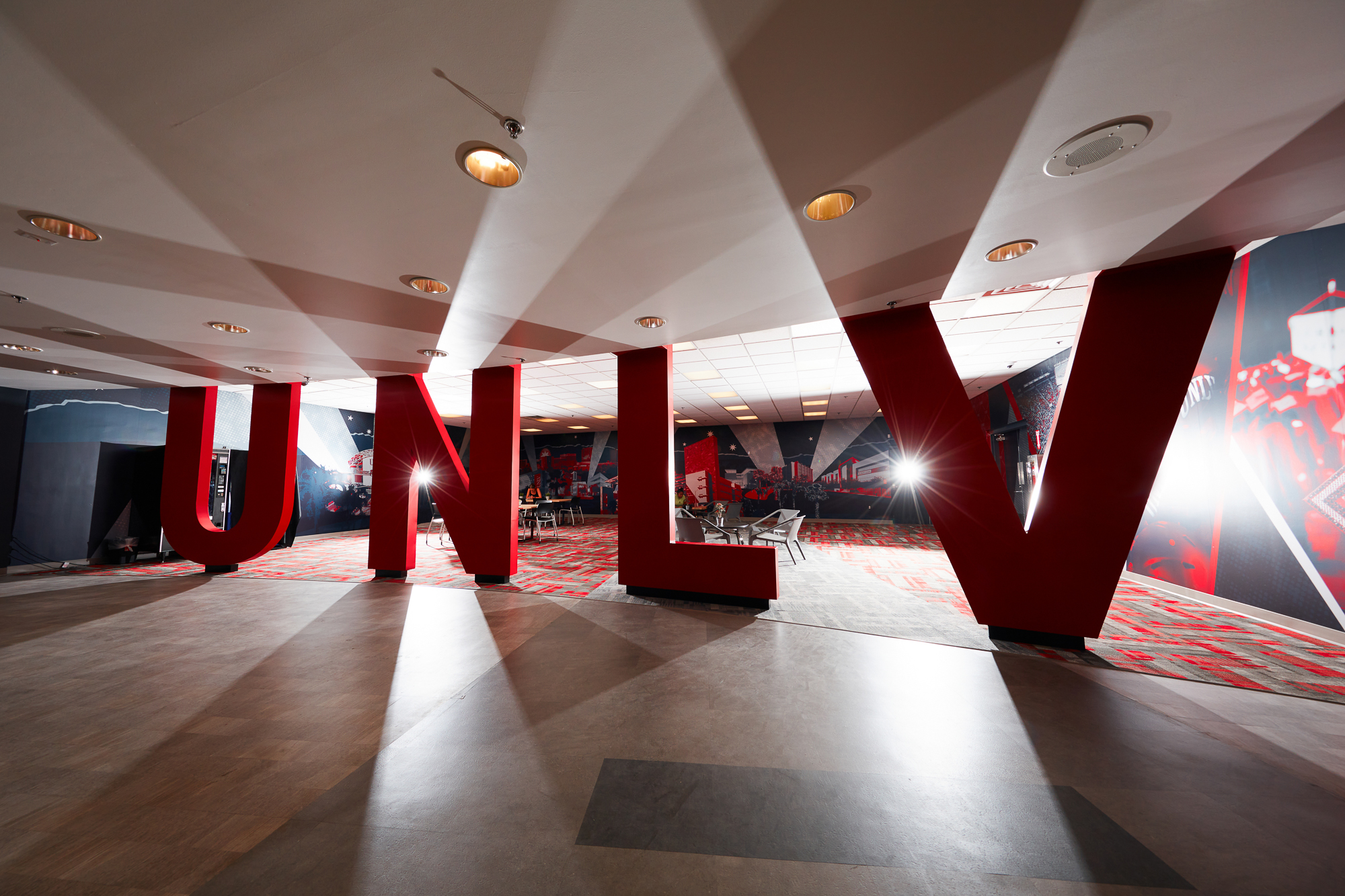 Study lounge in bookstore showing red UNLV letters in front of lights. 