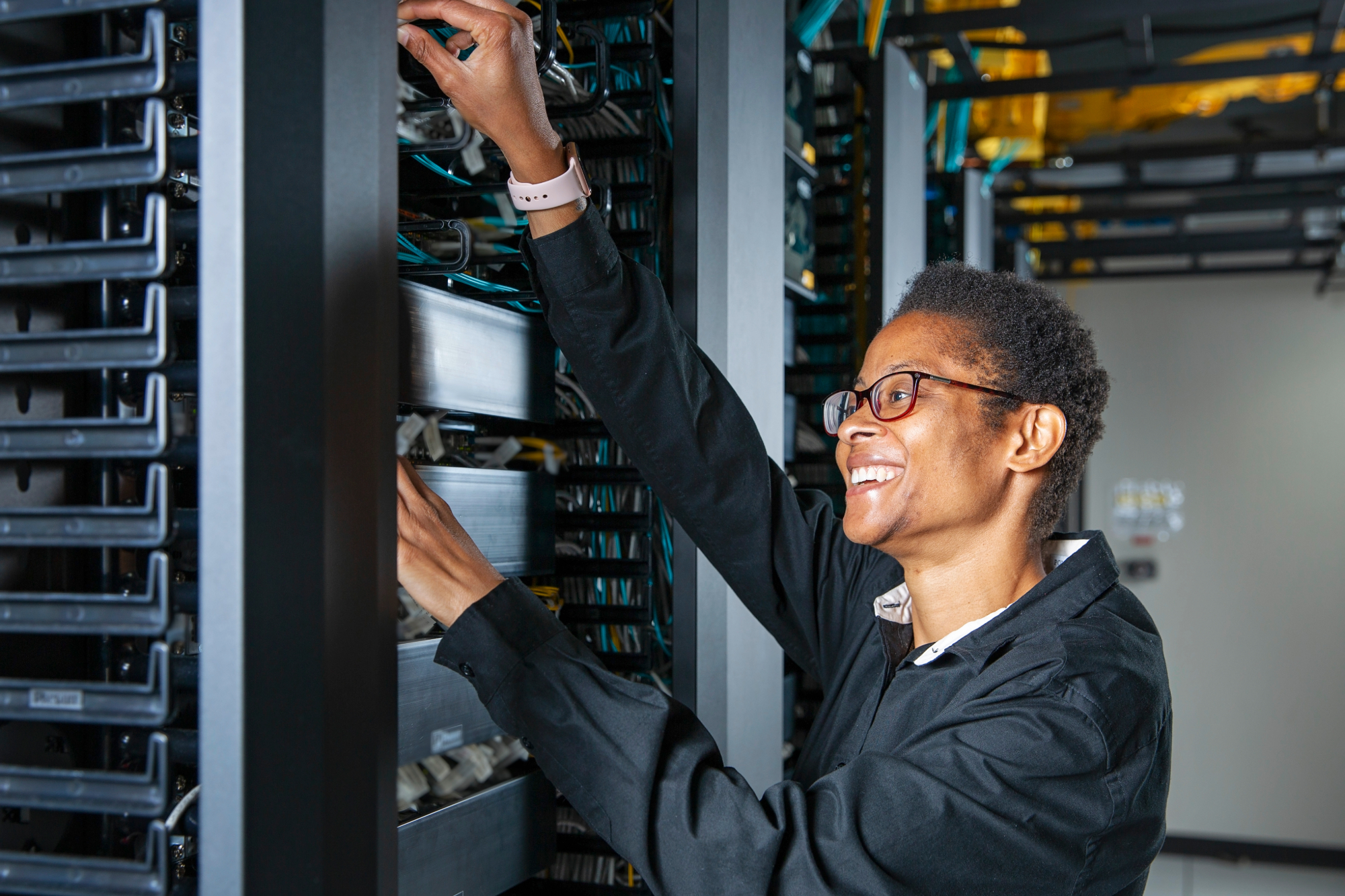 Person in data center looking into a server.