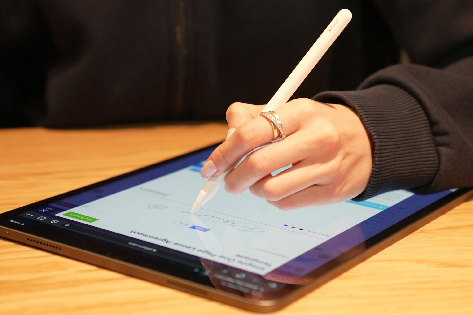 Person writing on a tablet with a stylus.