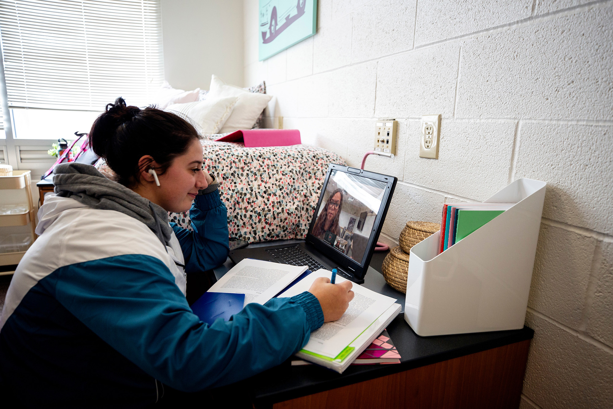 A female student studies in her dorm room.