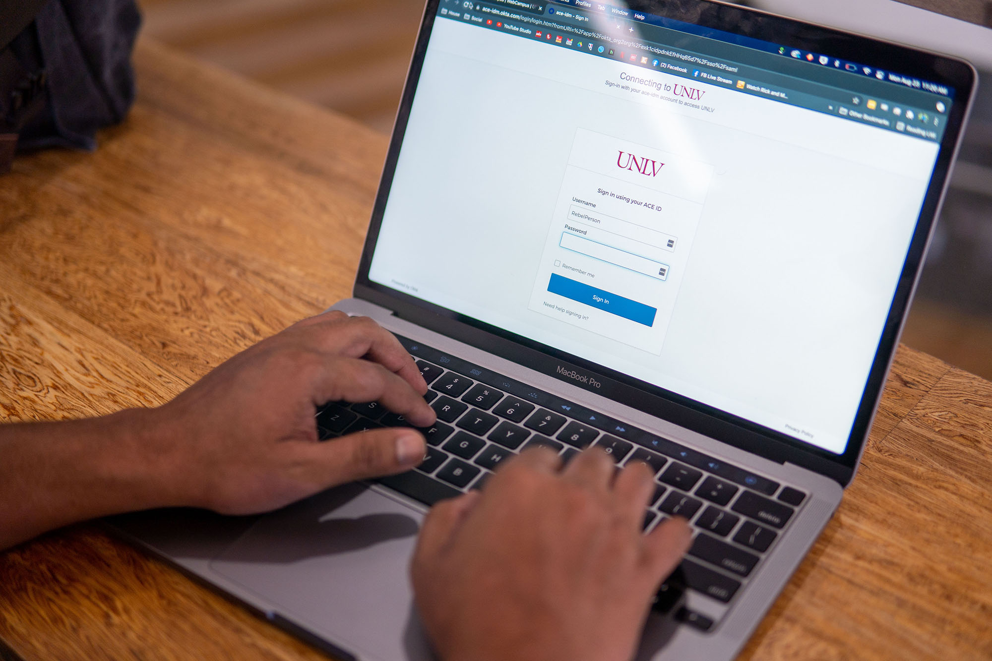 Hands typing on a laptop.