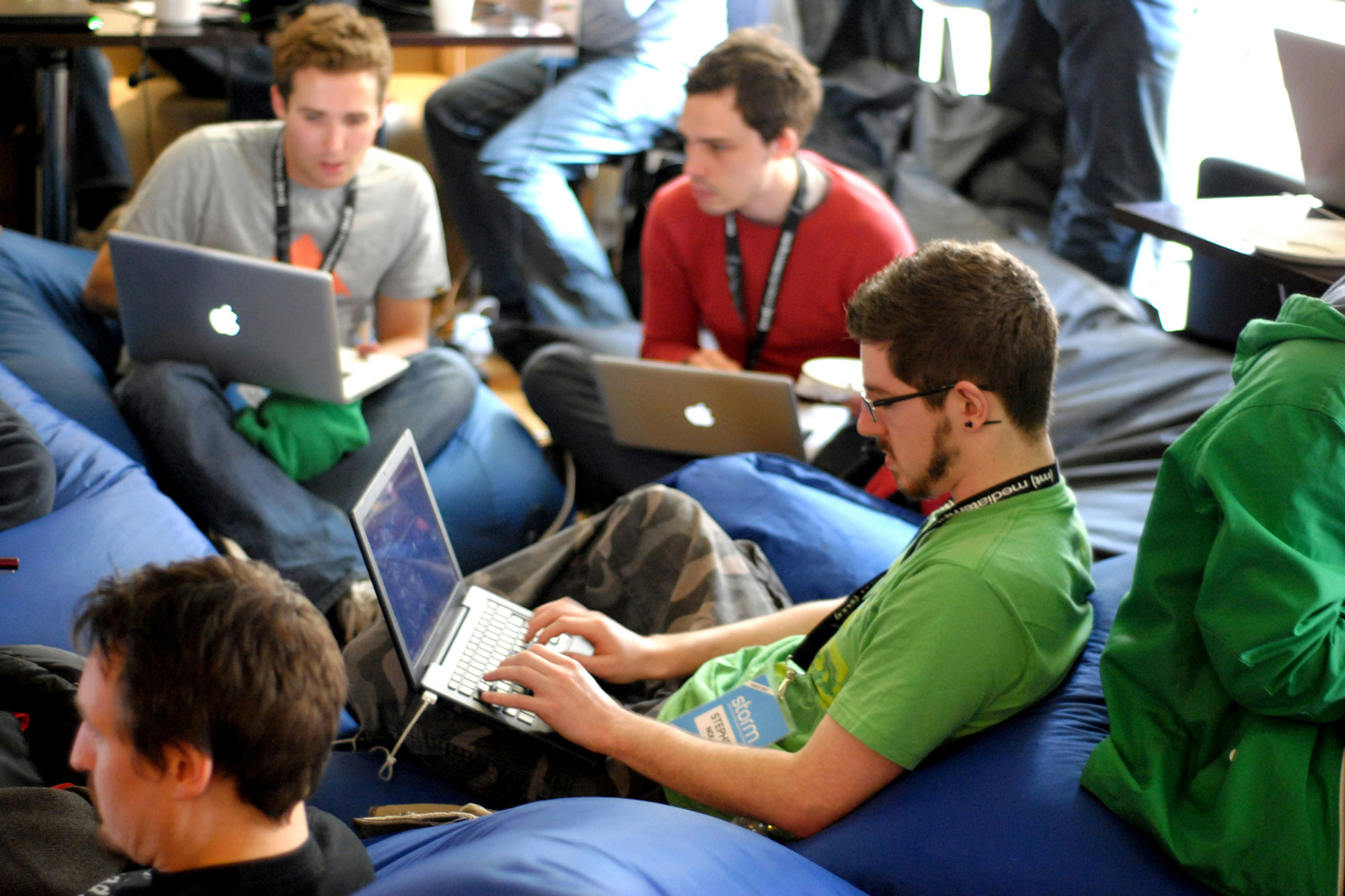 High school students sitting down and using laptops