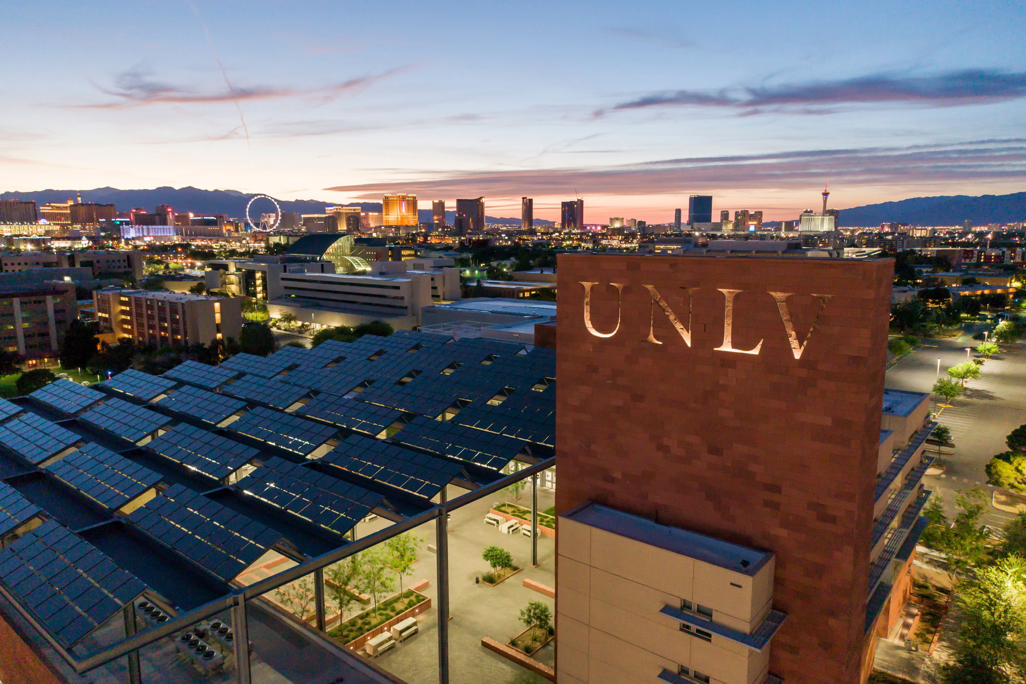 UNLV greenspun hall with a nighttime las vegas skyline in the background