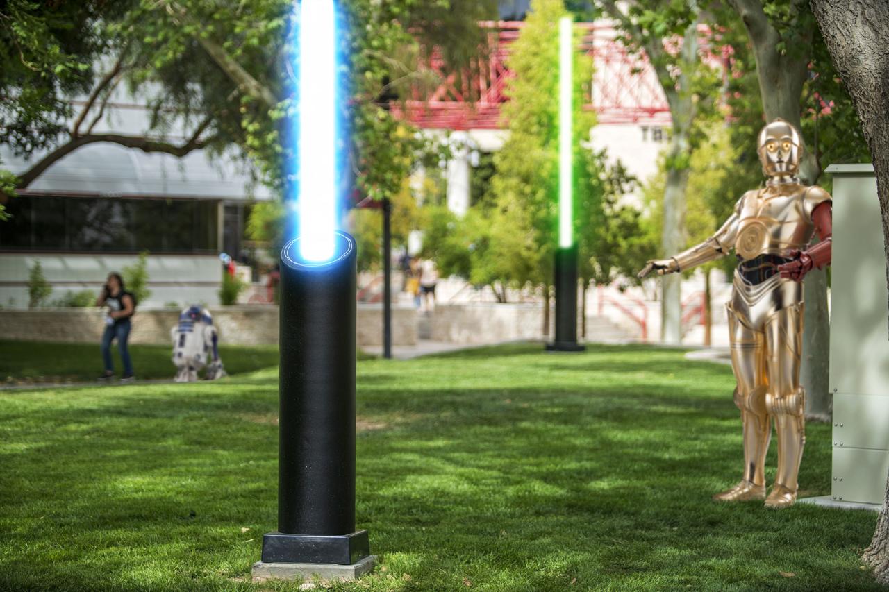 C3PO stares at light saber bollards.