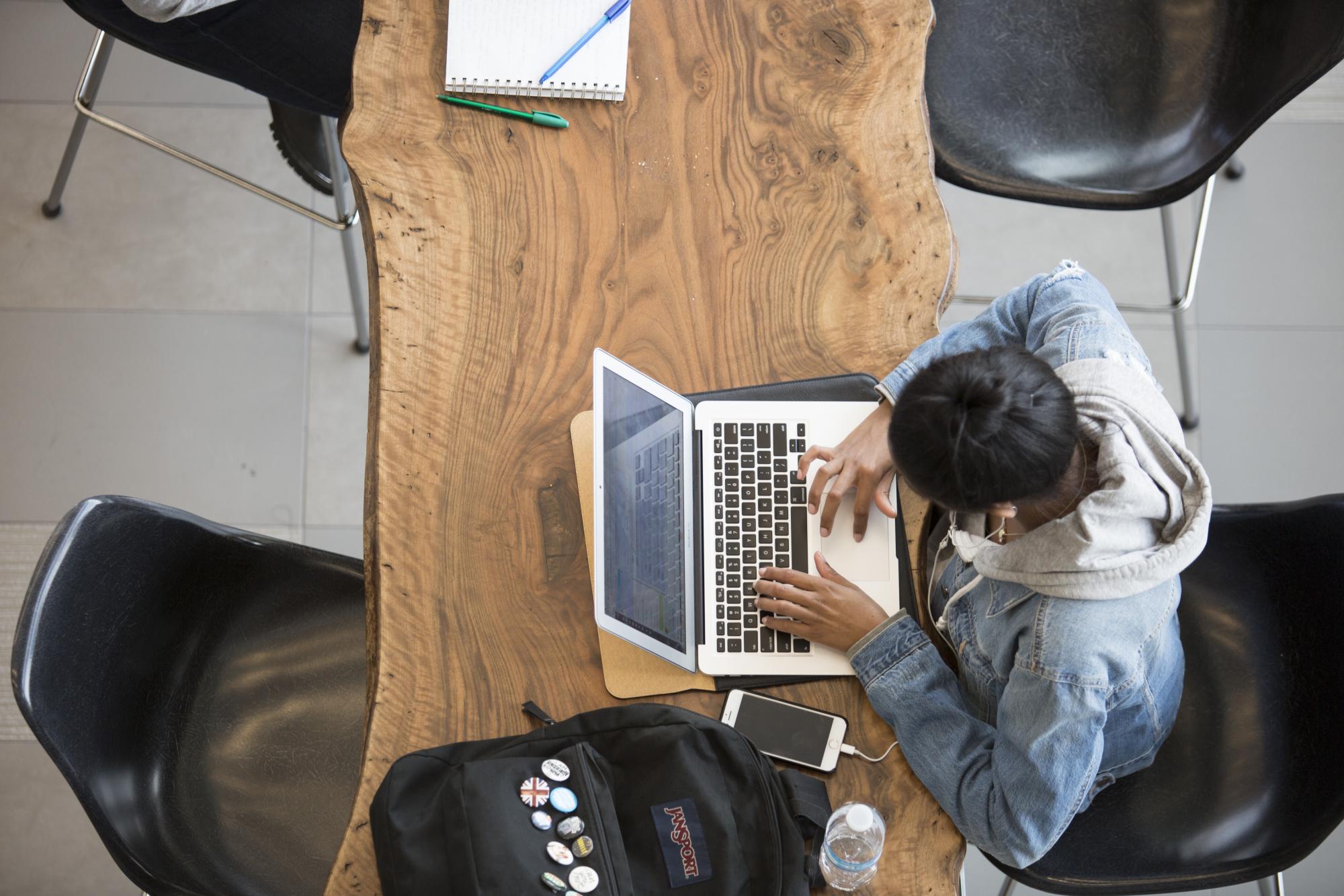 Person typing on laptop at table