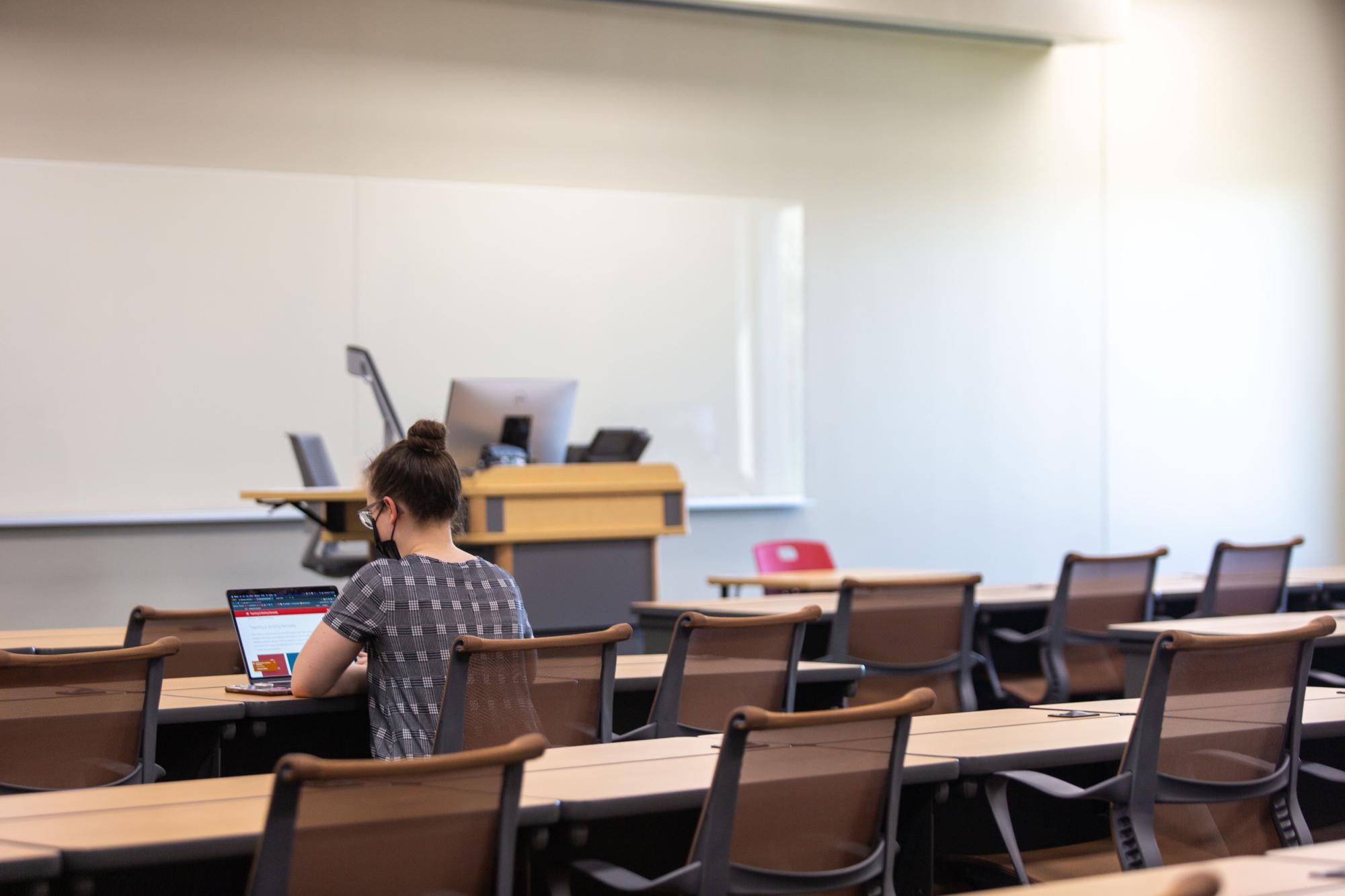 Person sitting at a desk using a laptop computer