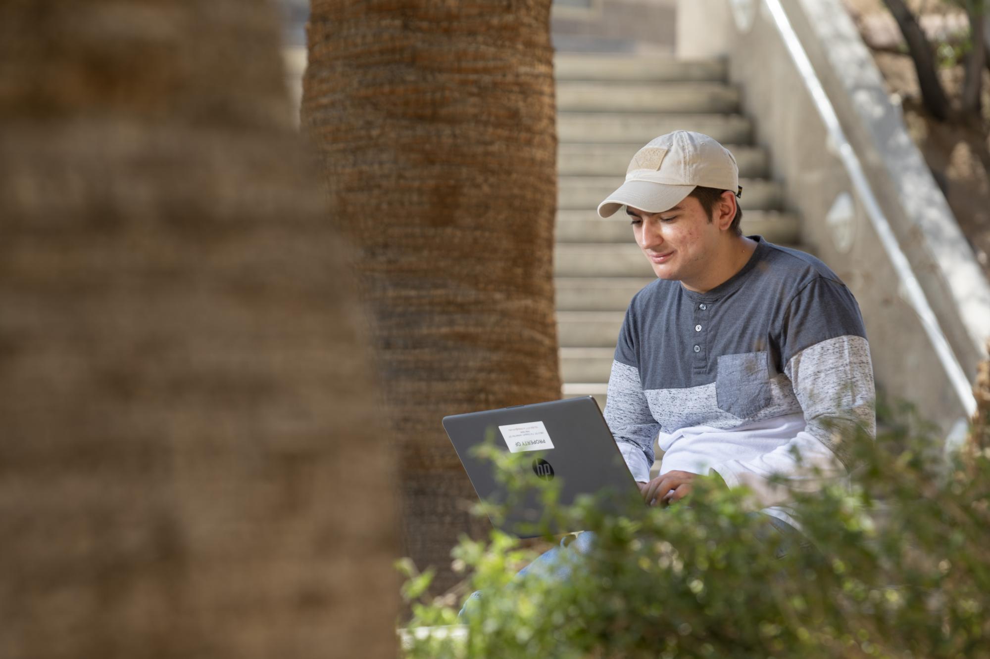 Person sitting typing on laptop computer