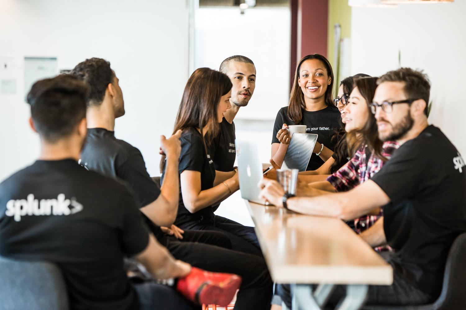 People sitting at table wearing Splunk shirts