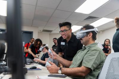 Instructor using VR technology inside the Immersive Learning Lab.