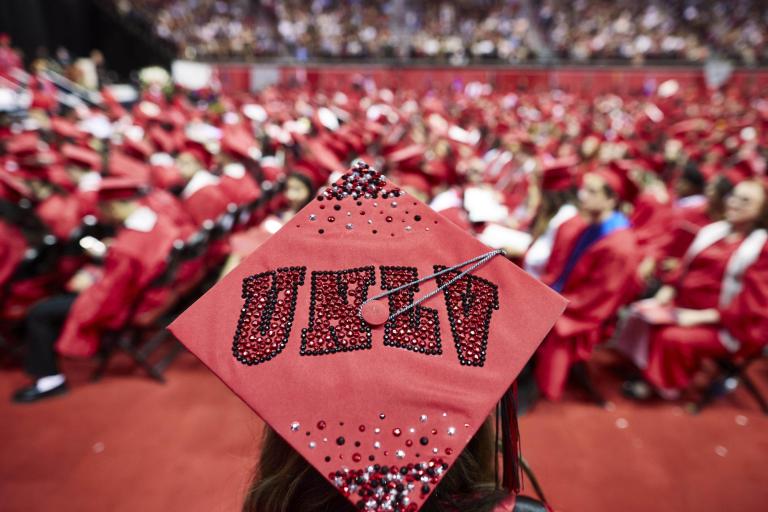 Graduation cap with red UNLV letters.