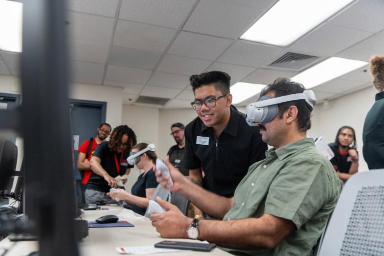 Instructor using VR technology inside the Immersive Learning Lab.