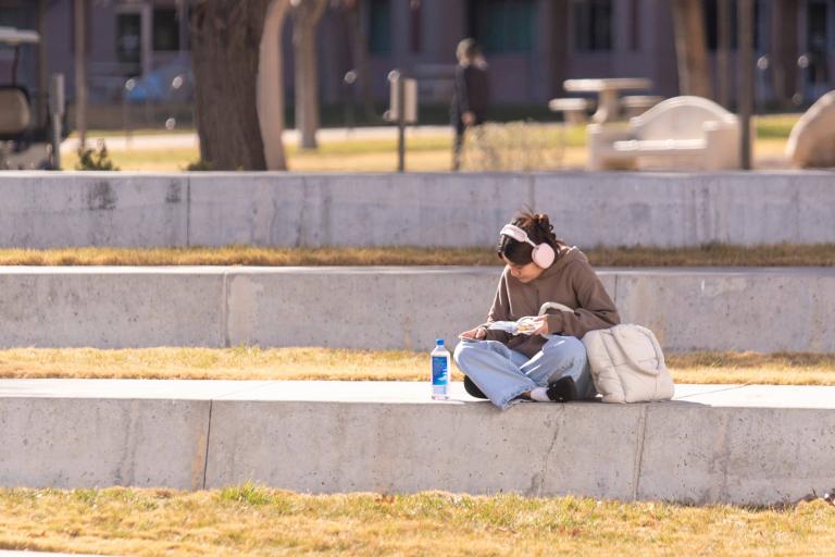 Student sitting in UNLV's academic mall.