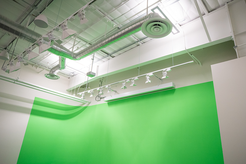 Room facing the ceiling with green screen covering part of the wall